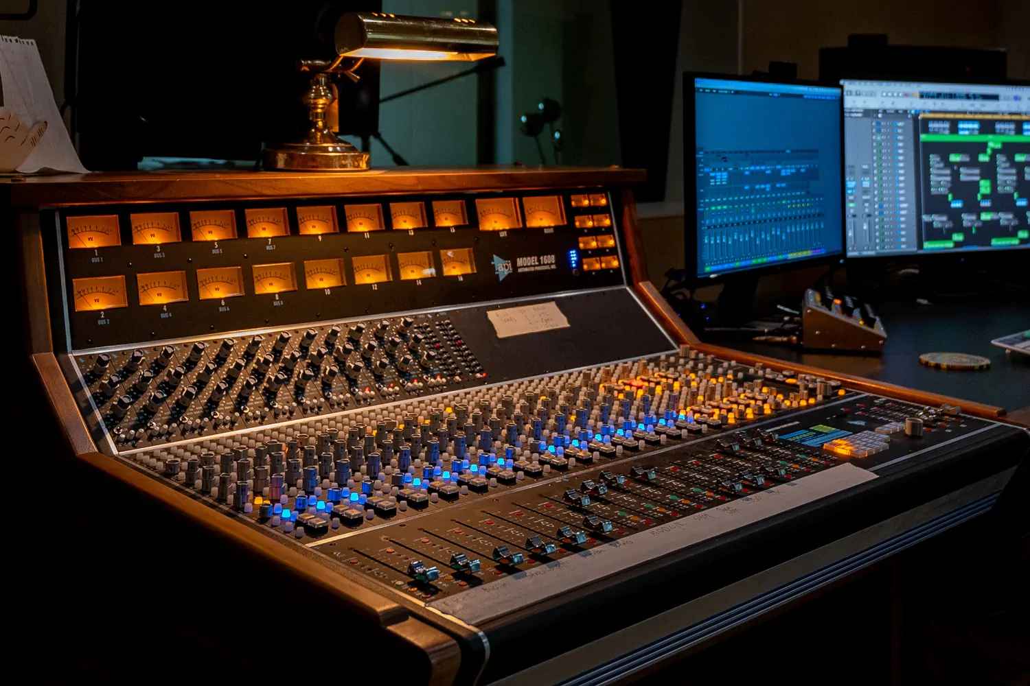 photo of api 1608-ii recording console in Fall On Your Sword Studios, dark and moody with glowing VU meters and Logic pro in the background